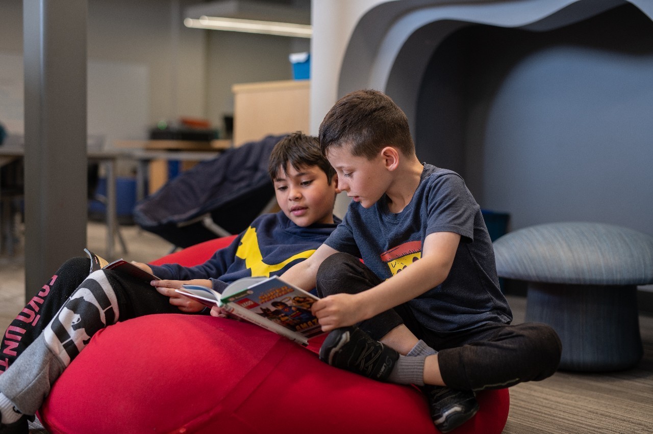 Two students read together at High Plains Elementary School.